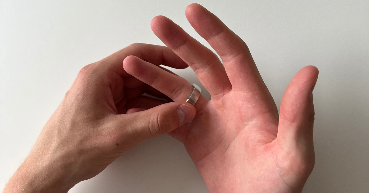 Hand turning the ratchet ring on another hand, palm faced up