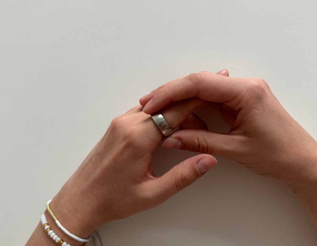 Neat female hands wearing bracelets turning the ratchet ring.