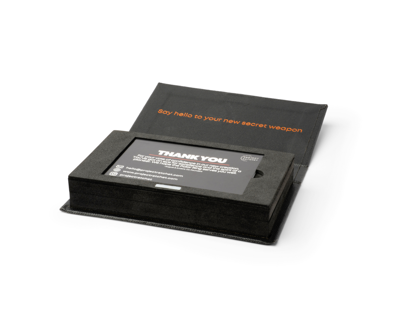 An open Project Ratchet ring box with certificate of authenticity card laying in it.