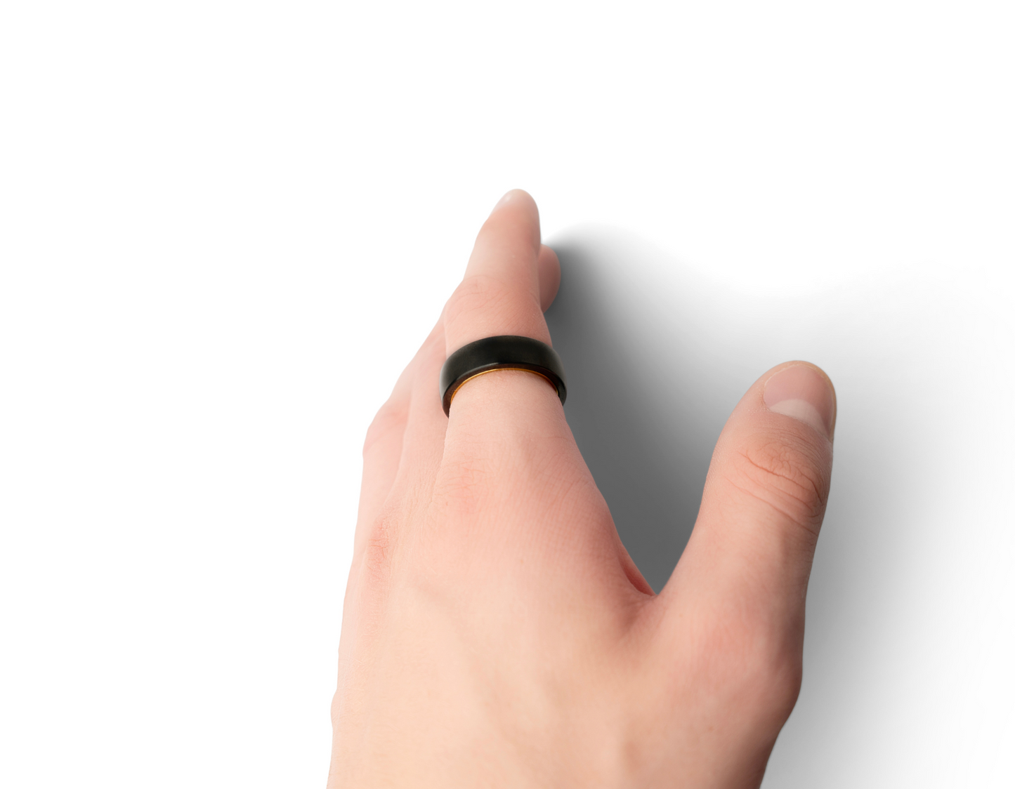 A hand wearing the Two-Tone Ratchet Ring, showing off the golden inner part of the ring.