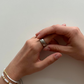 Female hands wearing bracelets turning the ratchet ring