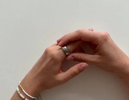 Female hands wearing bracelets turning the ratchet ring