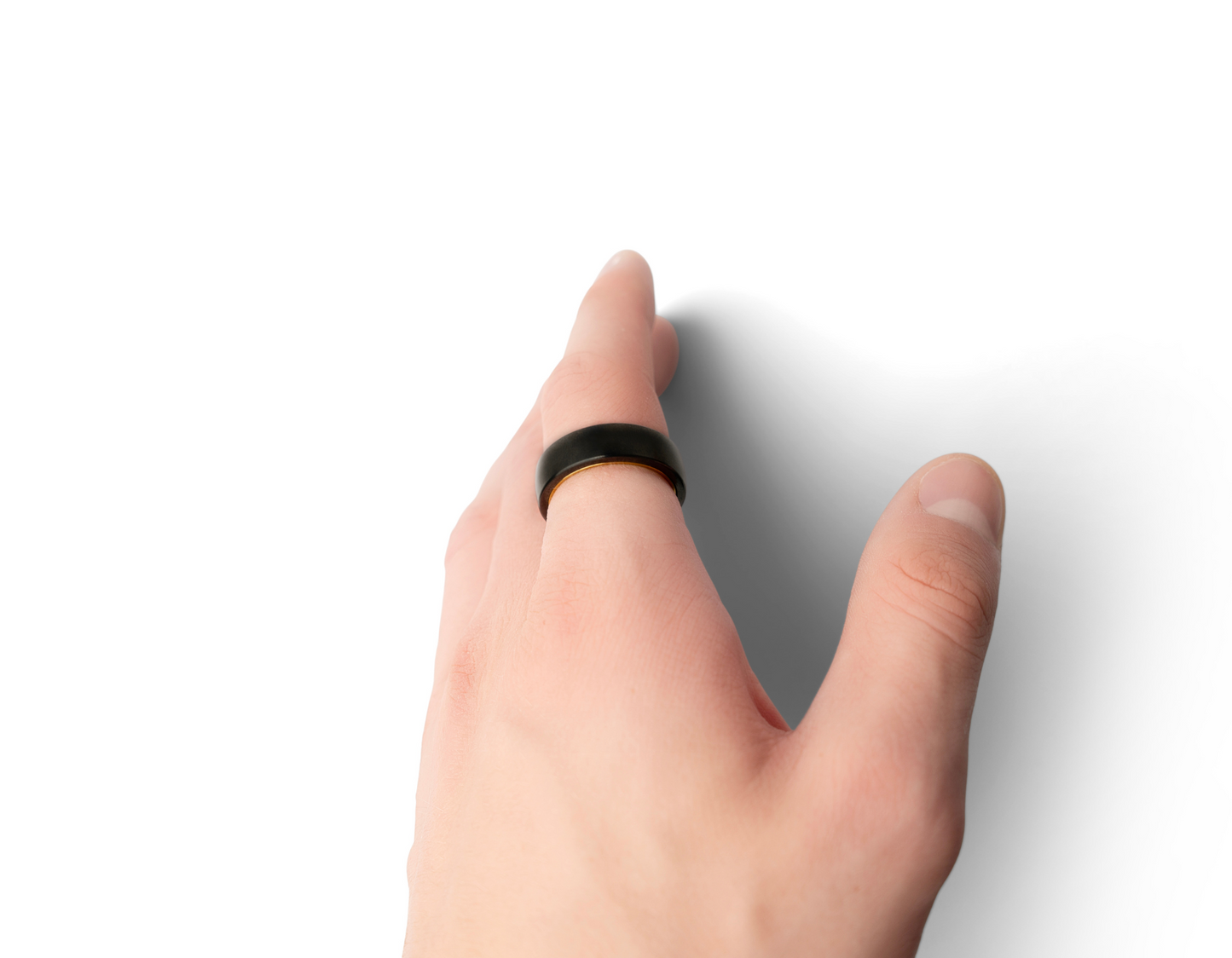 A hand wearing the Two-Tone Polar Ring, showing off the golden inner part of the ring.