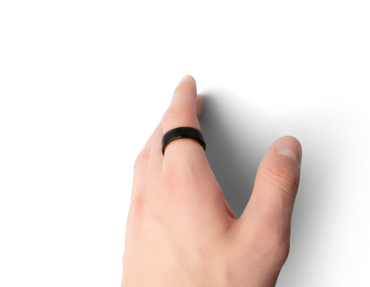 A hand wearing the Two-Tone Polar Ring, showing off the golden inner part of the ring.